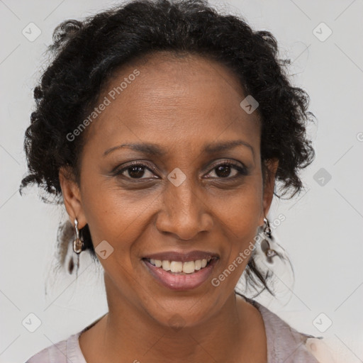 Joyful black adult female with short  brown hair and brown eyes