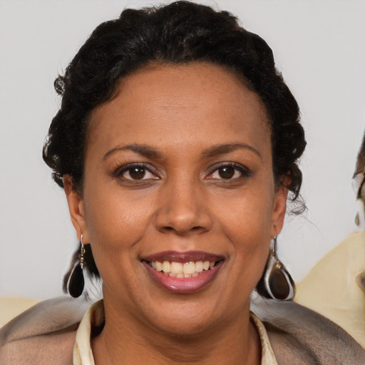 Joyful latino adult female with short  brown hair and brown eyes
