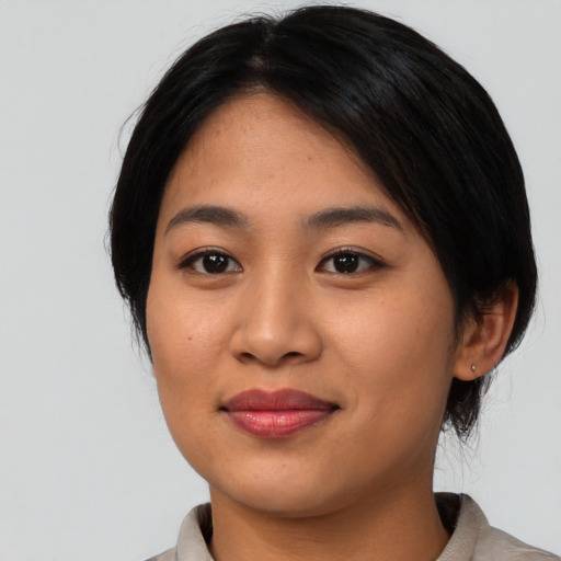 Joyful asian young-adult female with medium  black hair and brown eyes