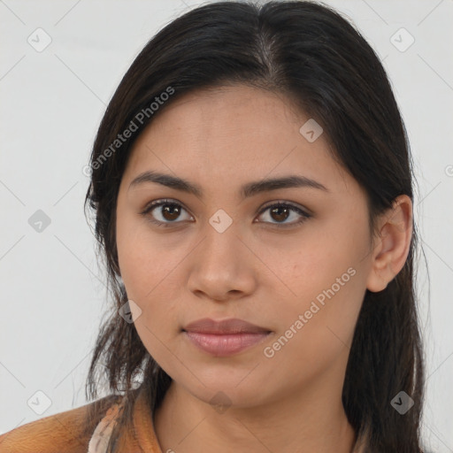 Joyful latino young-adult female with long  brown hair and brown eyes