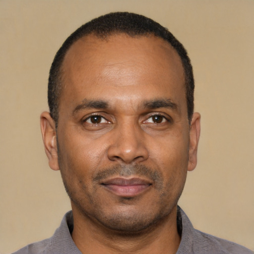 Joyful latino adult male with short  black hair and brown eyes