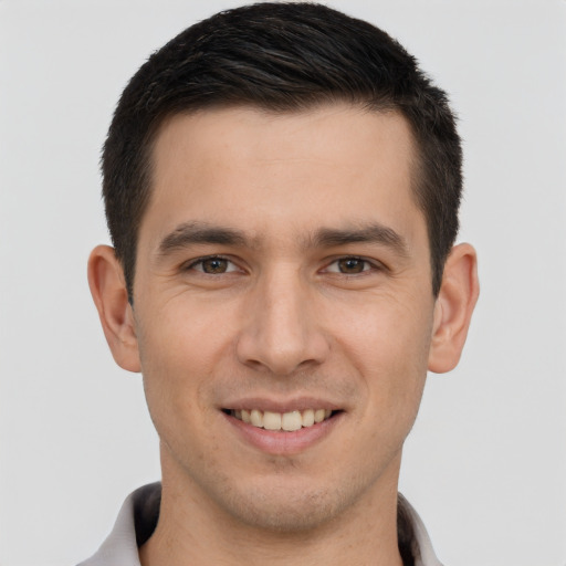 Joyful white young-adult male with short  brown hair and brown eyes