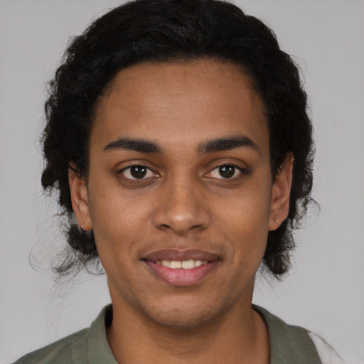 Joyful black young-adult male with short  brown hair and brown eyes