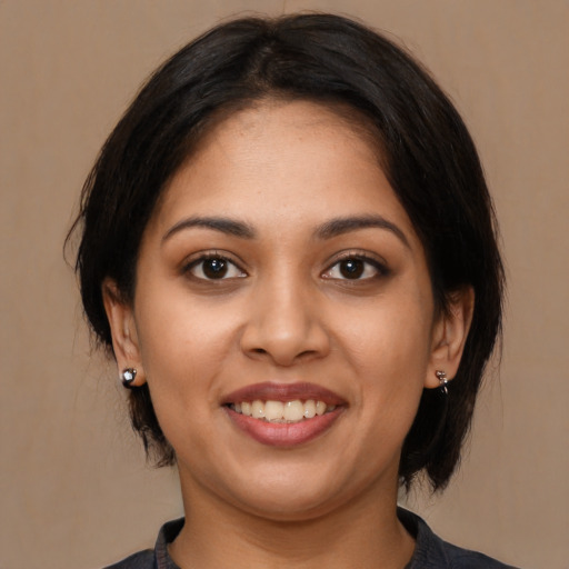 Joyful latino young-adult female with medium  black hair and brown eyes