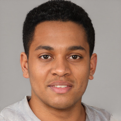 Joyful latino young-adult male with short  brown hair and brown eyes