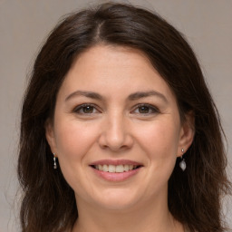 Joyful white adult female with long  brown hair and brown eyes