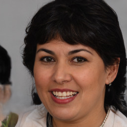 Joyful white adult female with medium  brown hair and brown eyes