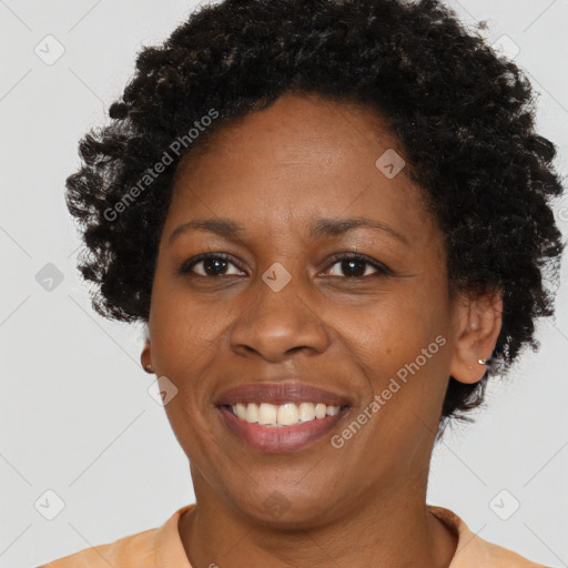 Joyful black adult female with short  brown hair and brown eyes