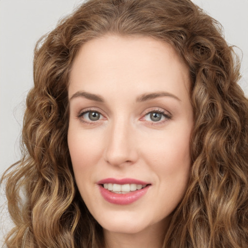 Joyful white young-adult female with long  brown hair and green eyes