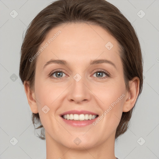 Joyful white young-adult female with medium  brown hair and green eyes