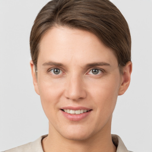 Joyful white young-adult female with short  brown hair and grey eyes