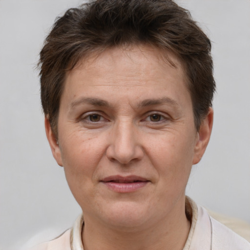 Joyful white adult female with short  brown hair and brown eyes