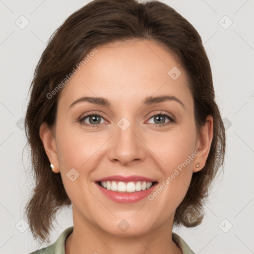 Joyful white young-adult female with medium  brown hair and green eyes