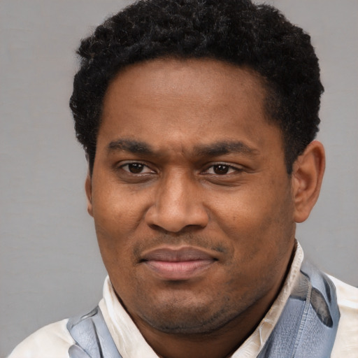 Joyful latino adult male with short  black hair and brown eyes