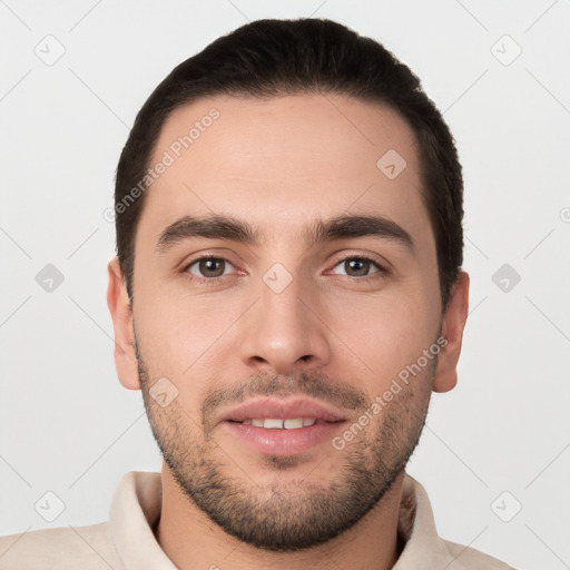 Joyful white young-adult male with short  black hair and brown eyes