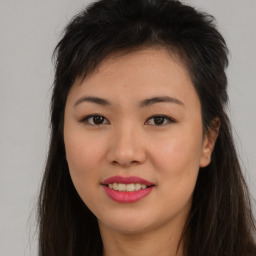 Joyful asian young-adult female with long  brown hair and brown eyes