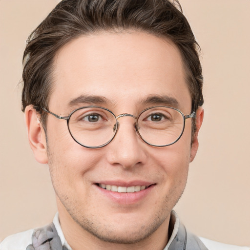 Joyful white adult male with short  brown hair and grey eyes