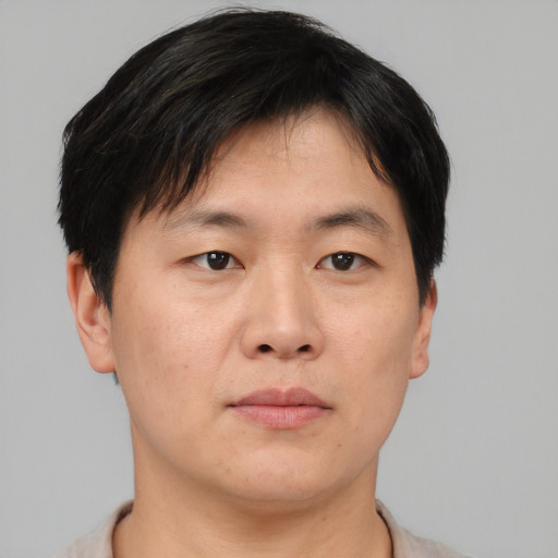 Neutral asian adult male with short  brown hair and brown eyes