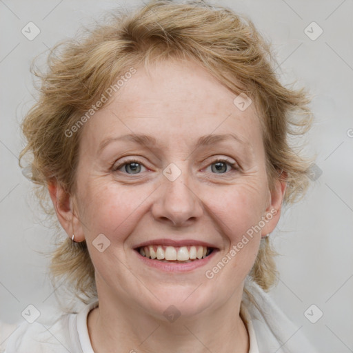 Joyful white adult female with medium  brown hair and blue eyes