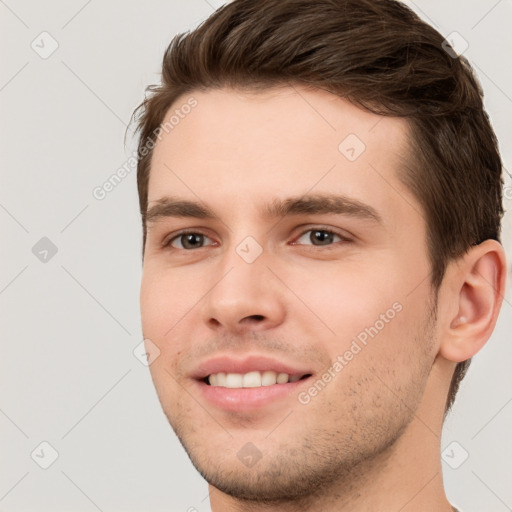 Joyful white young-adult male with short  brown hair and brown eyes