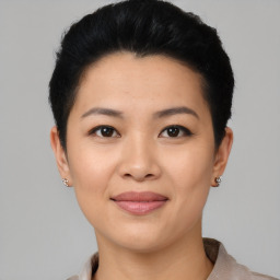 Joyful asian young-adult female with short  black hair and brown eyes