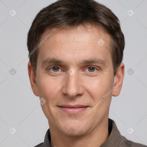 Joyful white adult male with short  brown hair and grey eyes