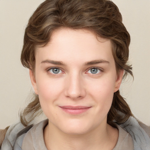 Joyful white young-adult female with medium  brown hair and blue eyes