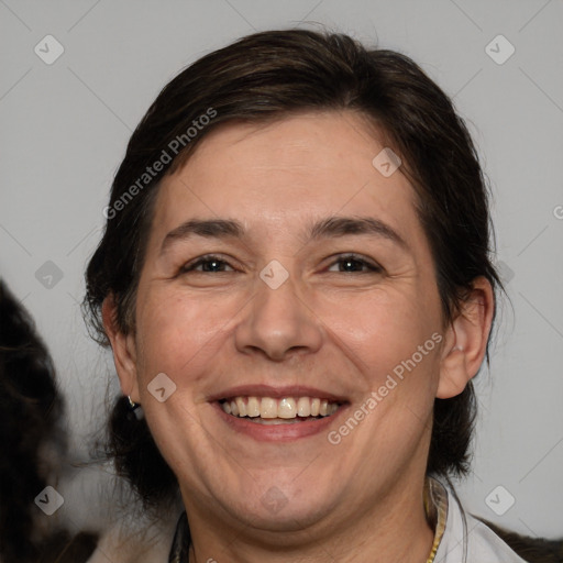 Joyful white adult female with medium  brown hair and brown eyes