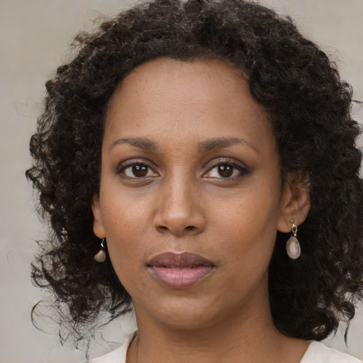 Neutral black young-adult female with medium  brown hair and brown eyes