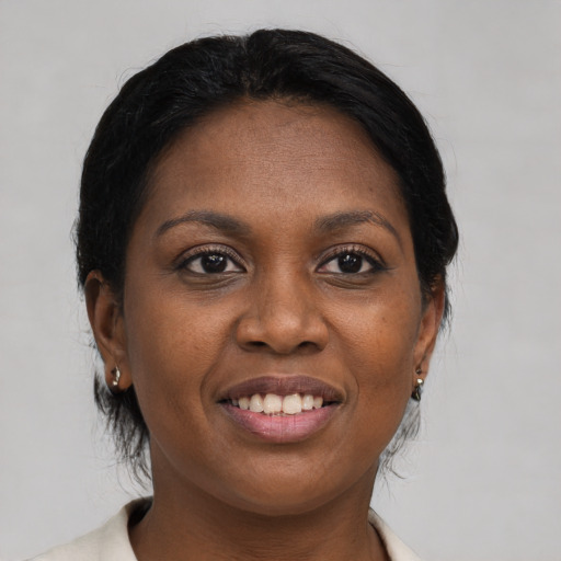 Joyful black young-adult female with medium  brown hair and brown eyes