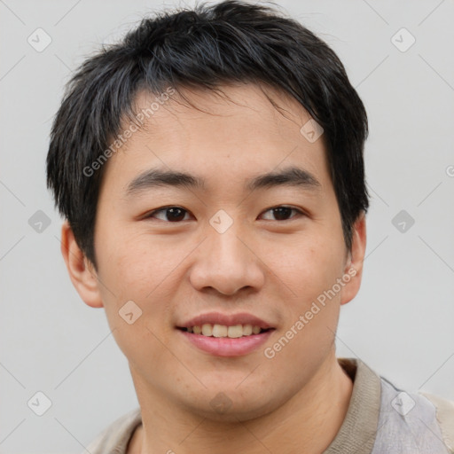 Joyful asian young-adult male with short  brown hair and brown eyes