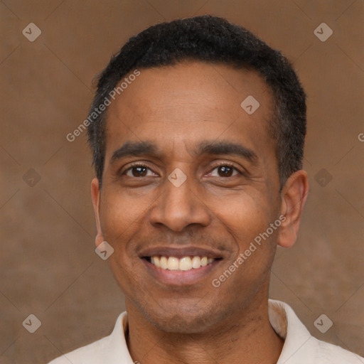 Joyful latino adult male with short  black hair and brown eyes