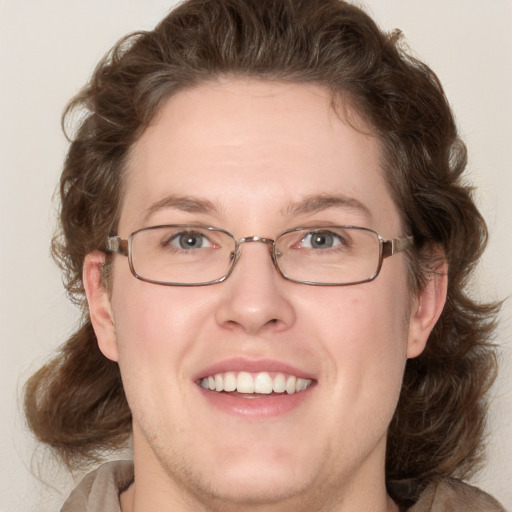 Joyful white adult female with medium  brown hair and blue eyes