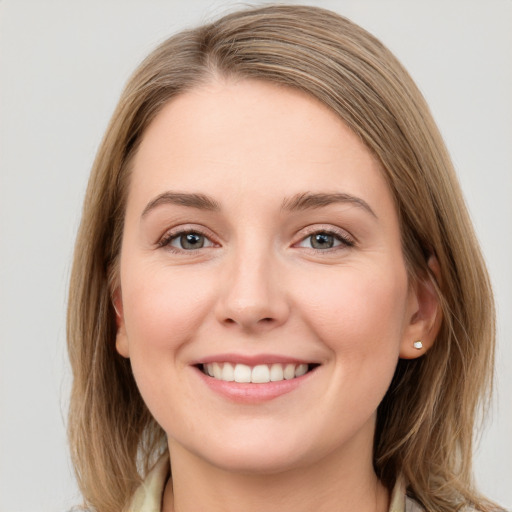 Joyful white young-adult female with long  brown hair and grey eyes