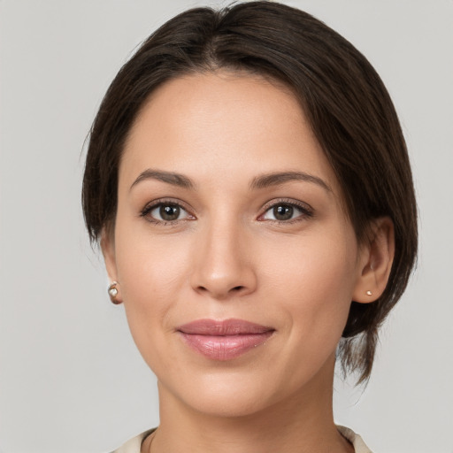 Joyful white young-adult female with medium  brown hair and brown eyes