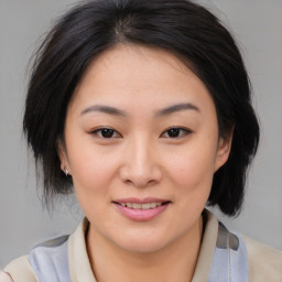 Joyful asian young-adult female with medium  brown hair and brown eyes