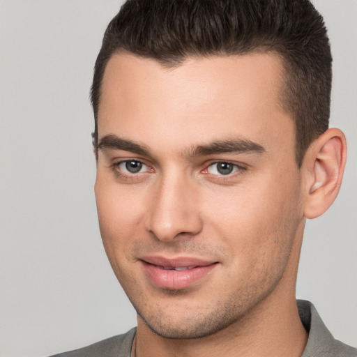 Joyful white young-adult male with short  brown hair and brown eyes