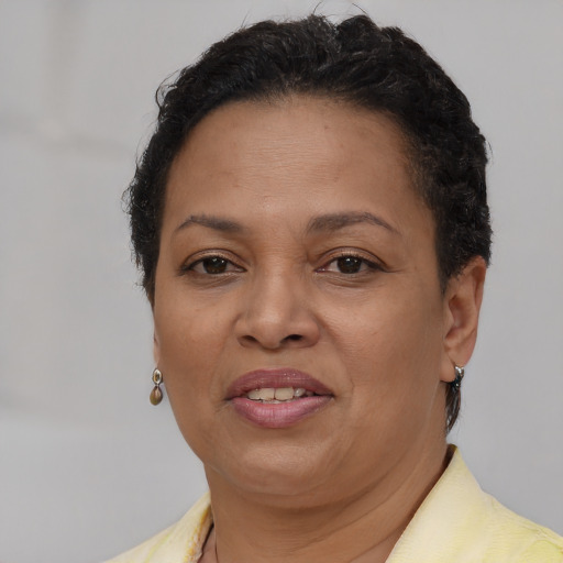 Joyful latino adult female with short  brown hair and brown eyes