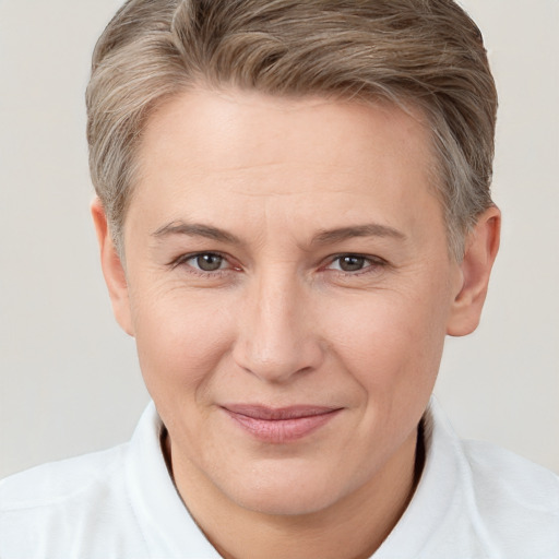 Joyful white adult female with short  brown hair and brown eyes