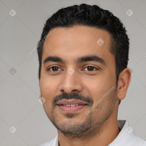 Joyful white young-adult male with short  black hair and brown eyes