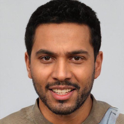 Joyful latino young-adult male with short  black hair and brown eyes