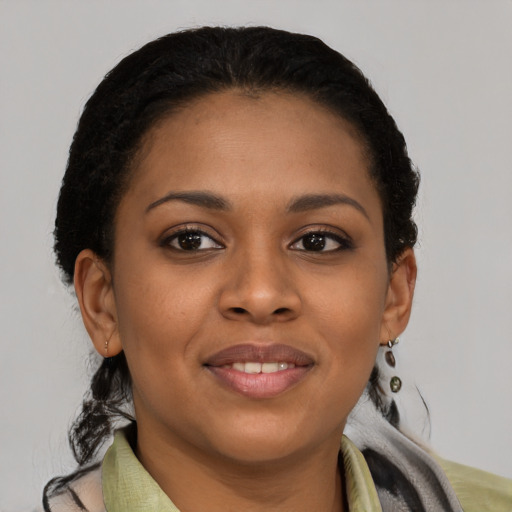 Joyful latino young-adult female with short  black hair and brown eyes