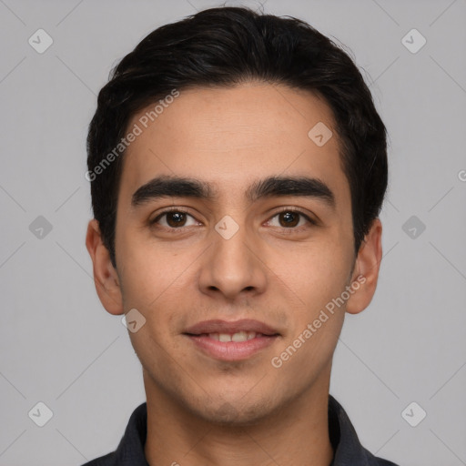 Joyful white young-adult male with short  black hair and brown eyes