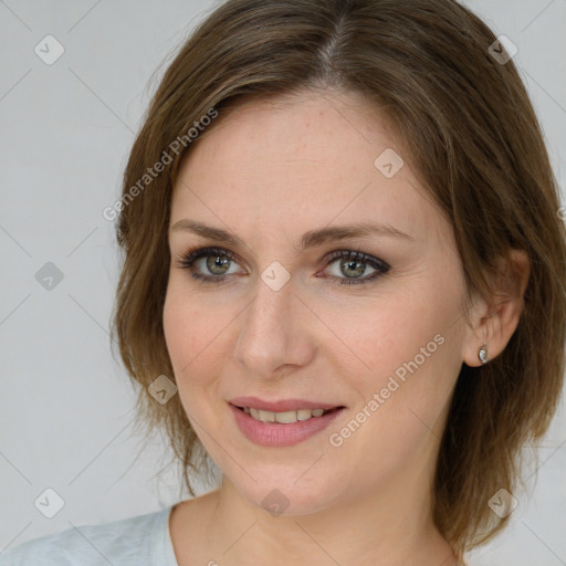 Joyful white young-adult female with medium  brown hair and green eyes