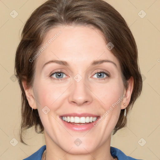 Joyful white adult female with medium  brown hair and blue eyes