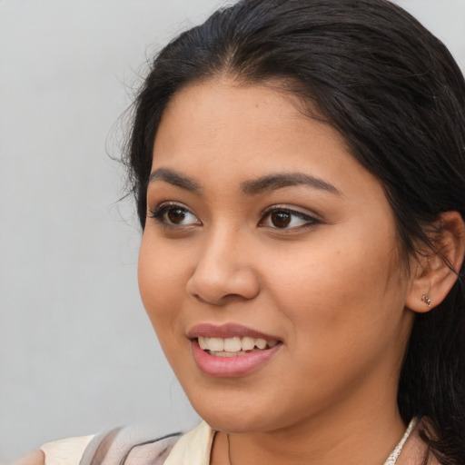 Joyful asian young-adult female with long  brown hair and brown eyes