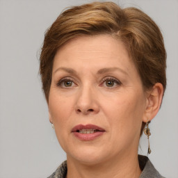 Joyful white adult female with medium  brown hair and grey eyes