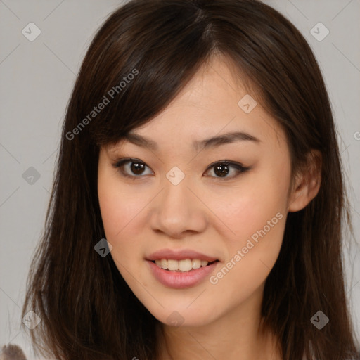 Joyful asian young-adult female with long  brown hair and brown eyes