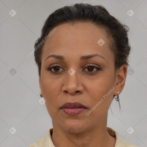 Joyful latino adult female with short  brown hair and brown eyes