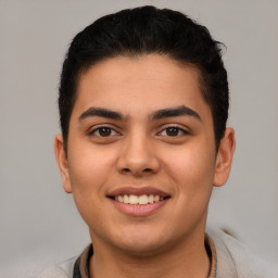 Joyful latino young-adult male with short  brown hair and brown eyes